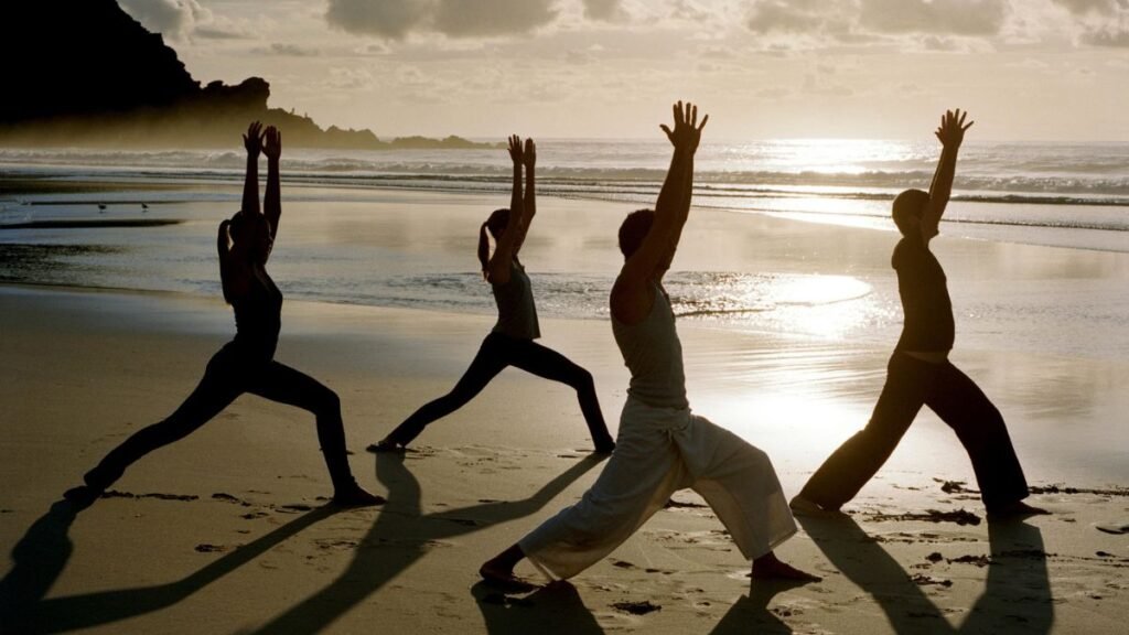 Yoga Certification: Your Complete Guide to Credentials, Career Paths, and Choosing the Right Program 1 doing yoga on the beach