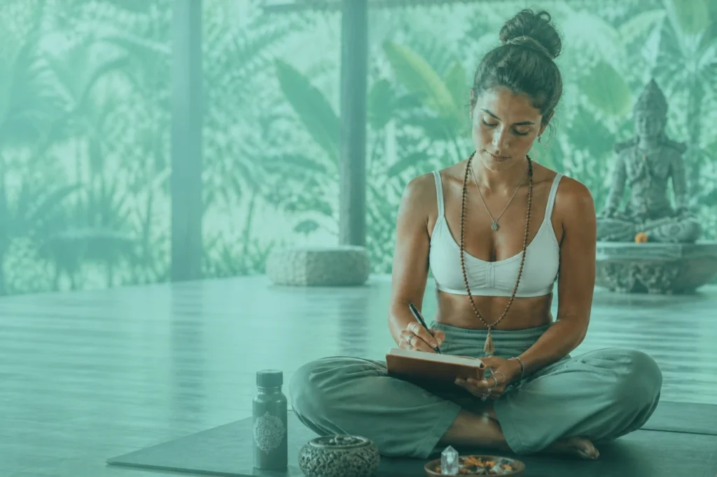 Yoga student reflecting after practice in a calm studio, representing the yamas and niyamas in daily life