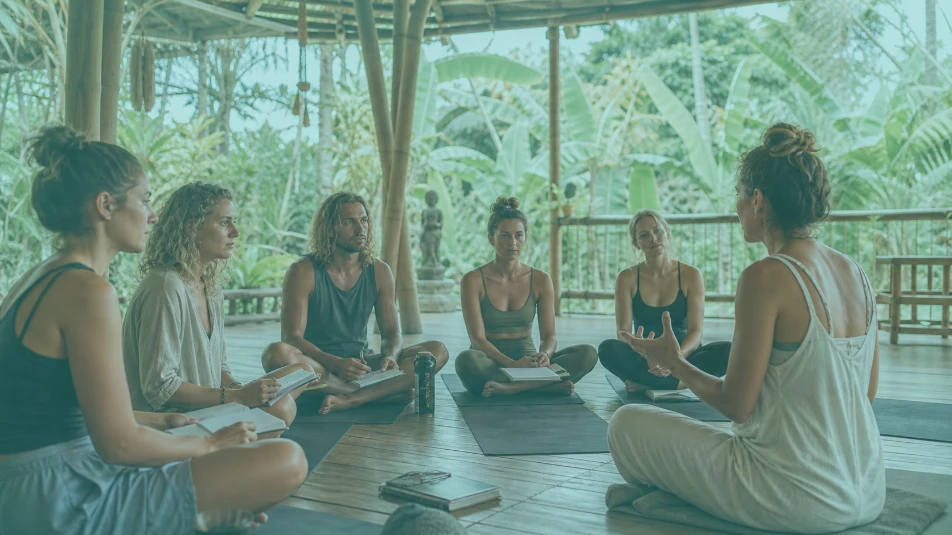Yoga teacher training students learning in an open-air Bali yoga shala